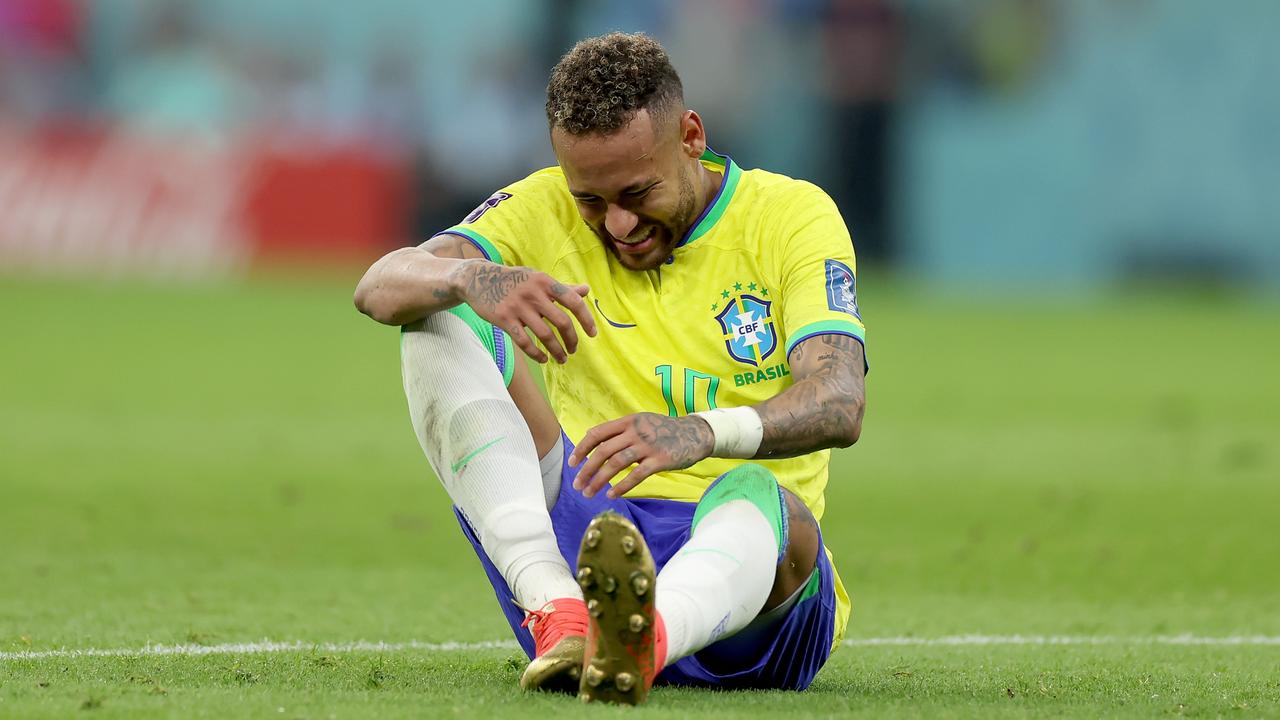 Neymar of Brazil sits injured on the pitch. (Photo by Lars Baron/Getty Images)