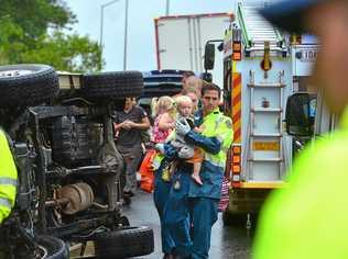 A car crashed and overturned in driving rain at the Parklands exit in the southbound lane just before 8am. A lady and two children were in the car and all were OK. Picture: John McCutcheon