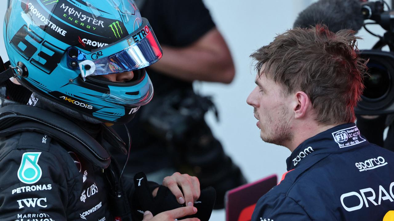 Mercedes' British driver George Russell and Red Bull Racing's Dutch driver Max Verstappen after the sprint race ahead of the Formula One Azerbaijan Grand Prix at the Baku City Circuit in Baku on April 29, 2023. (Photo by Giuseppe CACACE / AFP)