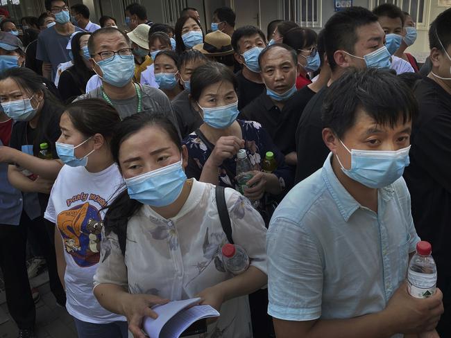 Workers and customers who have had contact with the Xinfadi Wholesale Market line up for a COVID-19 test. Picture: Getty Images