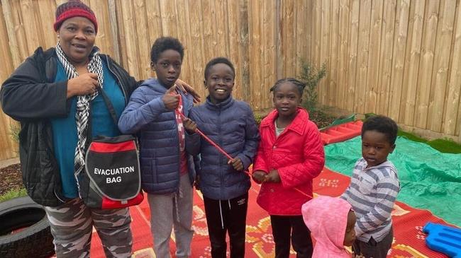 Family daycare worker Marie Pisua with the Osman siblings.