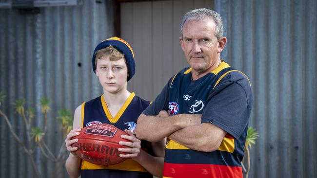 Crows fans Peter Murphy and his son Michael say they are “fed up with apologies”. Picture Mark Brake