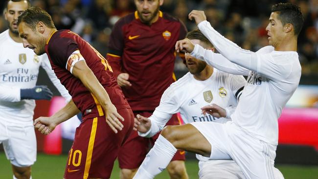 Cristiano Ronaldo tries to defend an attacking Francesco Totti .