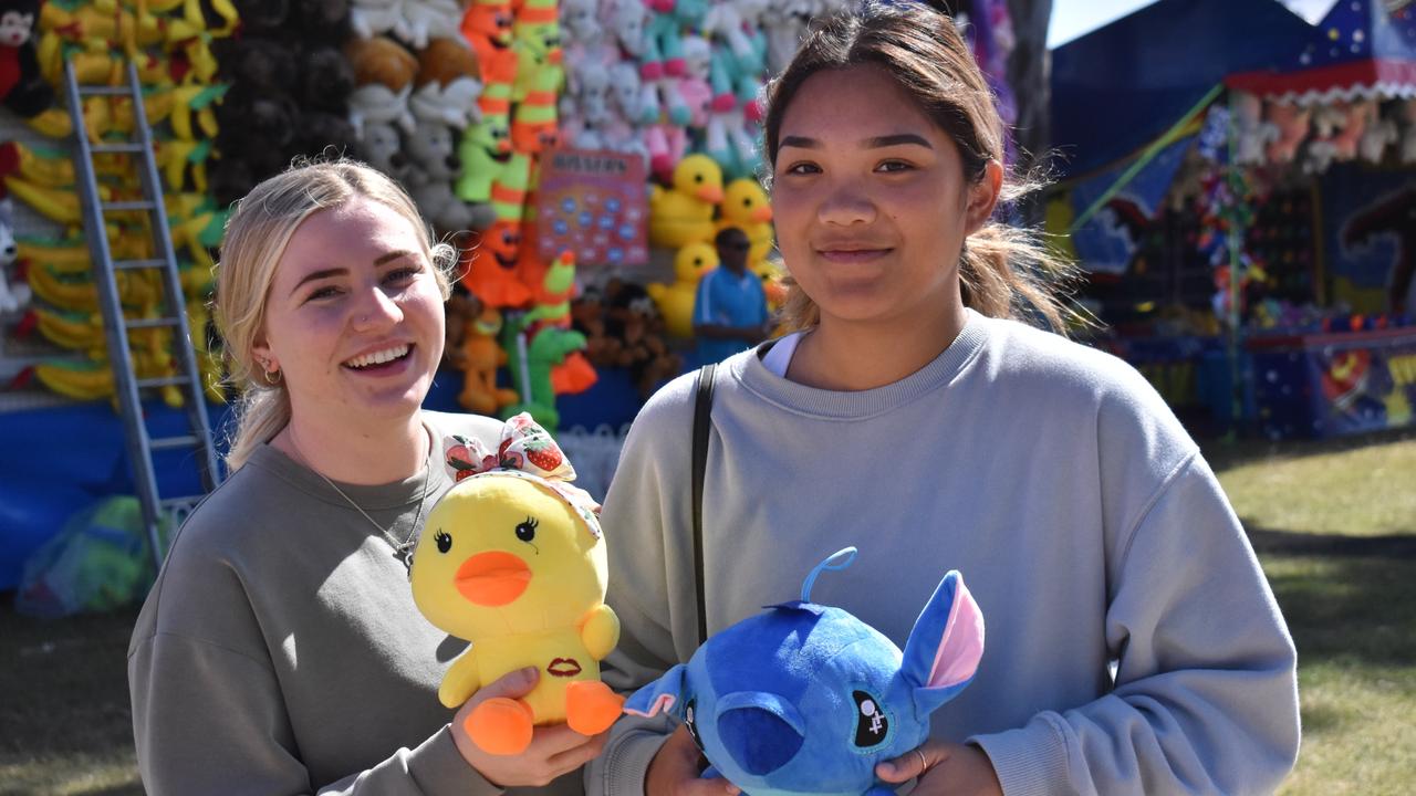 Sienna Maher and Isabel Dunn of Bowen won toys in a ball-throwing skill tester. Picture: Kirra Grimes