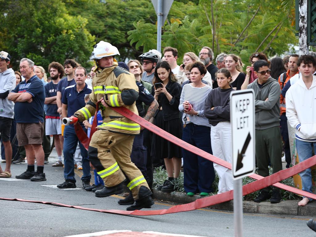 Onlookers as fire crews are battling multiple house fires in Evelyn Street in Grange. Photo: David Clark.