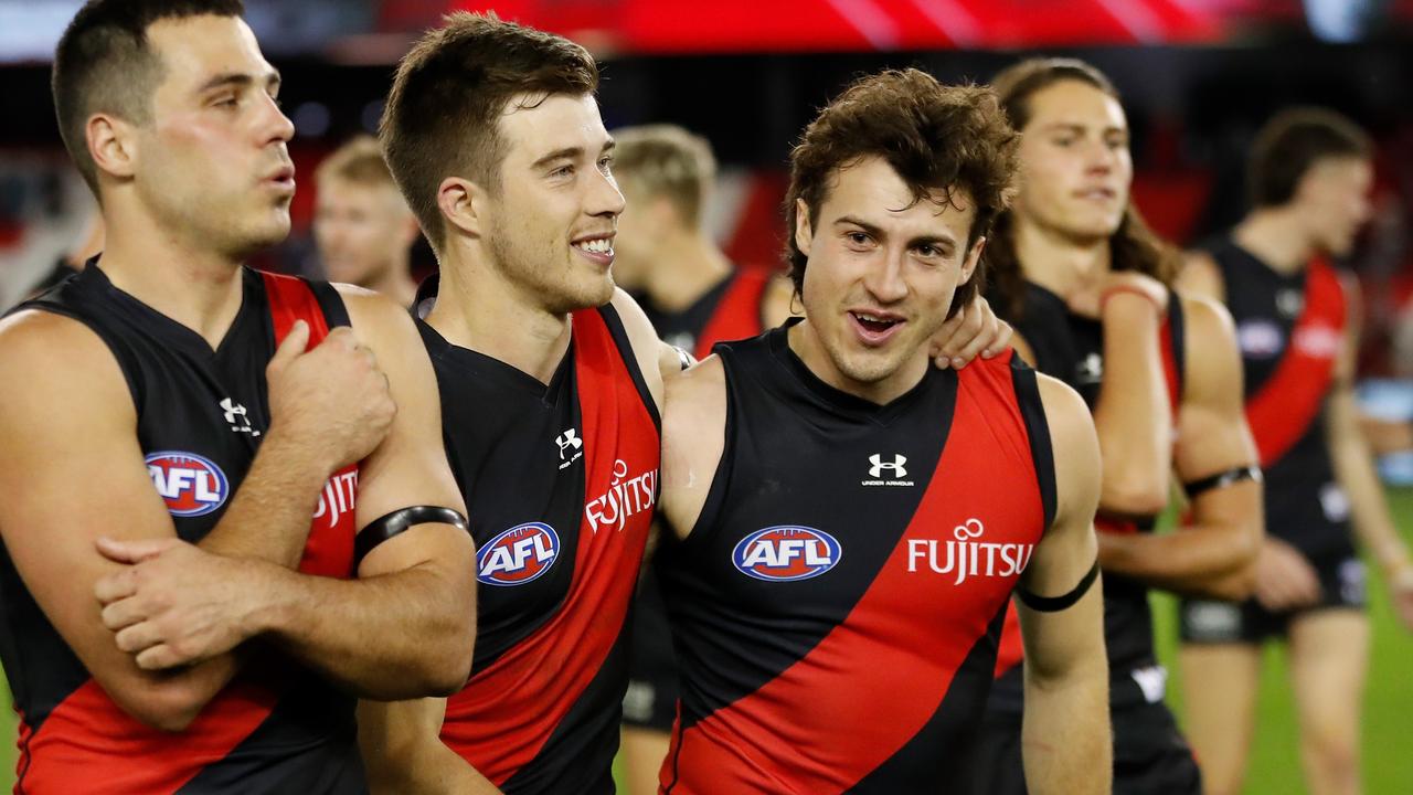 Alec Waterman, Zach Merrett and Andrew McGrath of the Bombers celebrate the win. Picture: Michael Willson