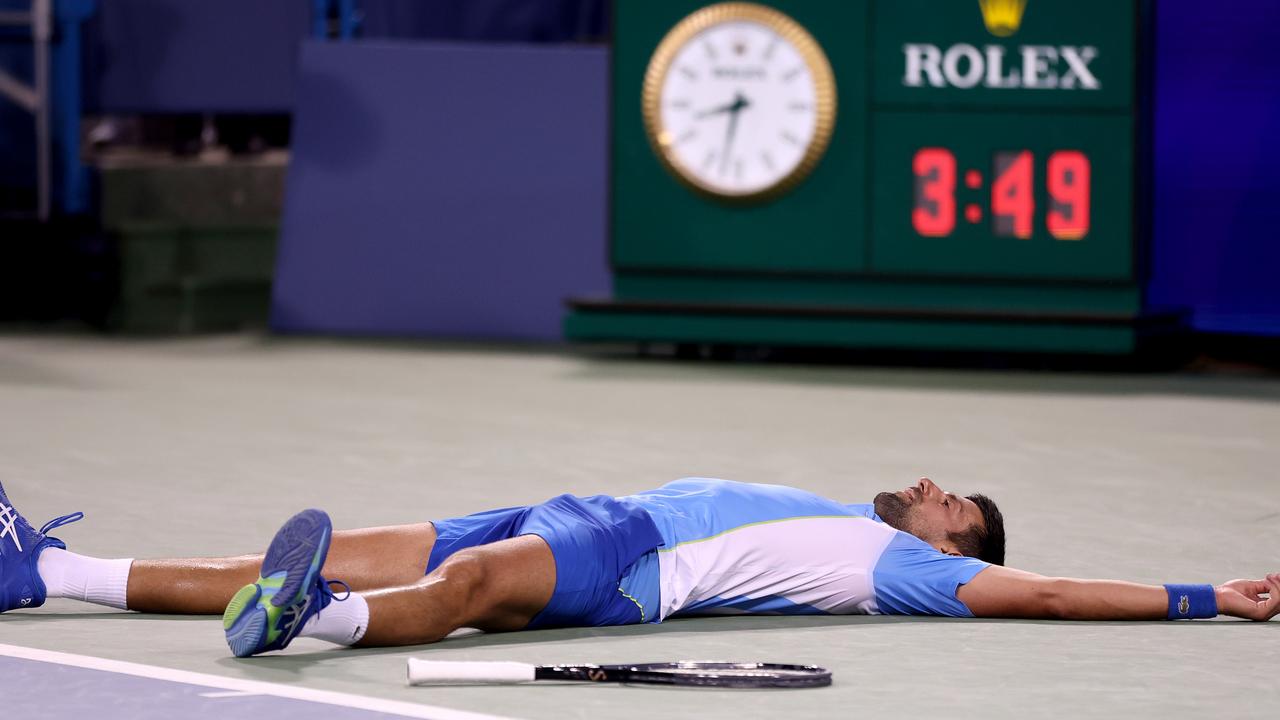 Novak Djokovic collapses after match point. Photo by Matthew Stockman/Getty Images.