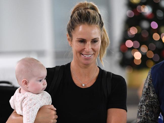 Candice Warner with her youngest child Isla at Melbourne Airport