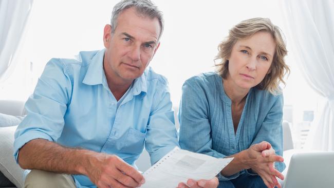 Worried couple juggling overdue bills. Picture: iStock.