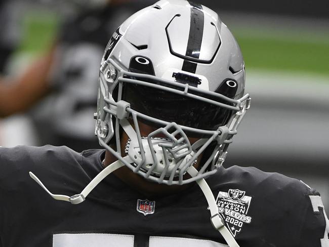 LAS VEGAS, NEVADA - DECEMBER 13:  Offensive tackle Trent Brown #77 of the Las Vegas Raiders wears a helmet featuring a raised fist design on the face mask as he warms up before a game against the Indianapolis Colts at Allegiant Stadium on December 13, 2020 in Las Vegas, Nevada. The Colts defeated the Raiders 44-27.  (Photo by Ethan Miller/Getty Images)