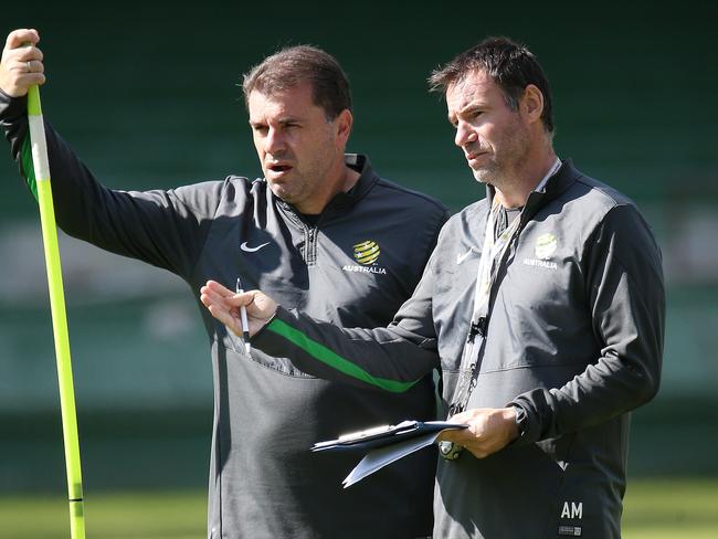 Ante Milicic talks tactics with Ange Postecoglou.