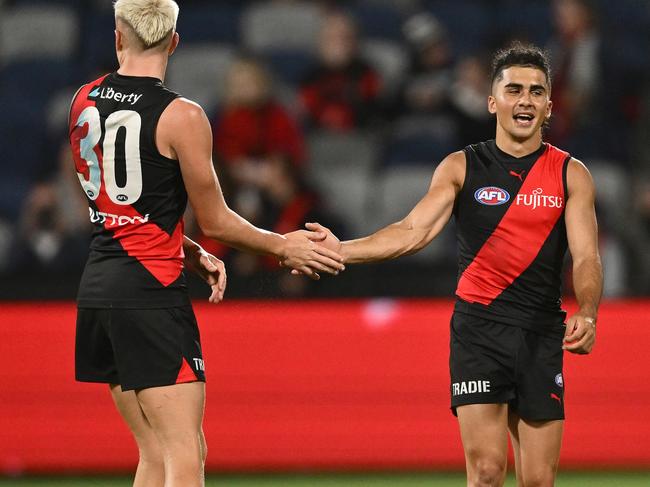 GEELONG, AUSTRALIA - FEBRUARY 25: Nate Caddy and Isaac Kako of the Bombers celebrate winning the 2025 AAMI AFL Community Series match between Geelong Cats and Essendon Bombers at GMHBA Stadium on February 25, 2025 in Geelong, Australia. (Photo by Quinn Rooney/Getty Images)