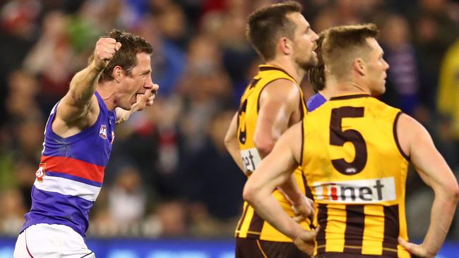 Dale Morris celebrates on the final siren as Luke Hodge and Sam Mitchell watch on.