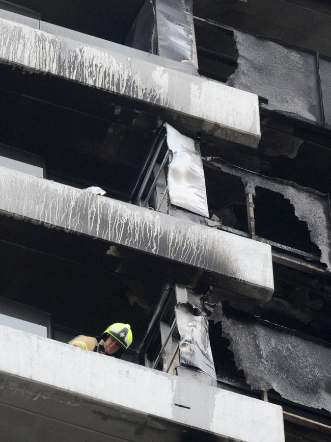 Fire crews inspecting the damage yesterday. Picture: Andrew Henshaw