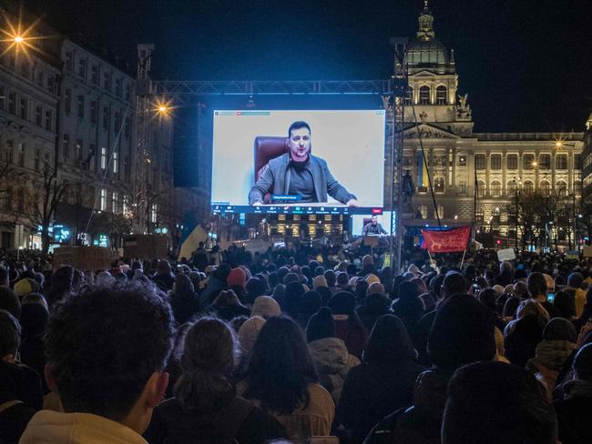 Protestors listen to Ukrainian President Volodymr Zelensky. Picture: AFP