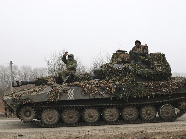 In this photo taken from video distributed by Russian Defense Ministry Press Service on Friday, March 14, 2025, Russian soldiers ride atop of self-propelled gun at an area in the Kursk region of Russia after it was taken over by Russian troops. (Russian Defense Ministry Press Service via AP)