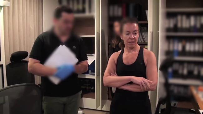 Melissa Caddick speaking with ASIC officers during the raid on her house. Picture: Supplied.