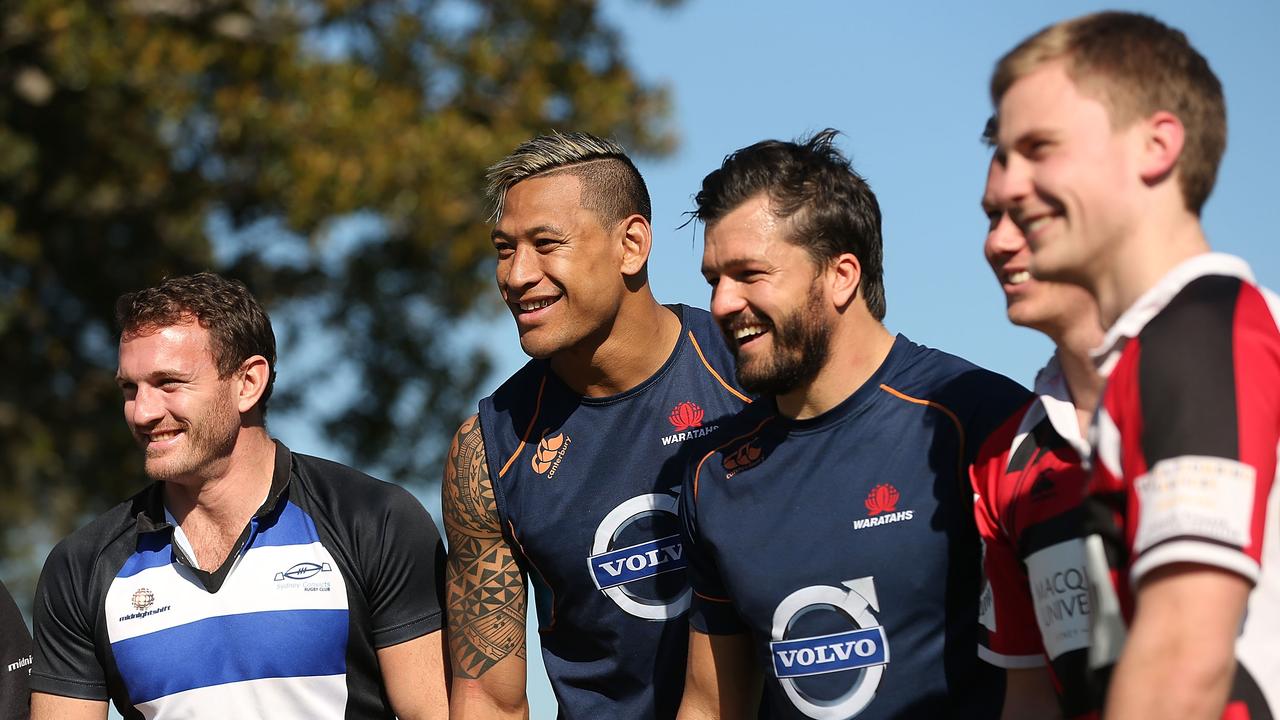 Israel Folau and Adam Ashley-Cooper pose with players from the Sydney Convicts during a Waratahs training session at Kippax Lake on July 3, 2014 in Sydney.