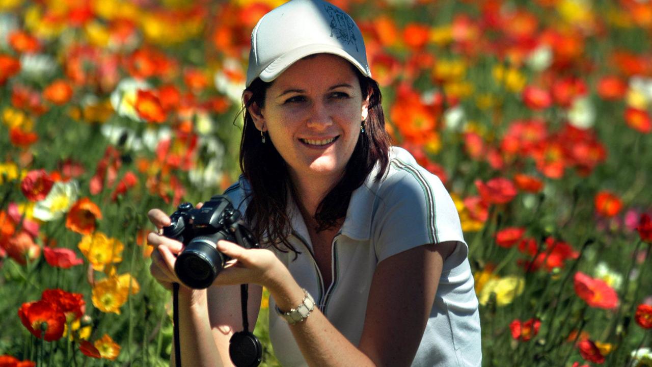 Toowoomba Carnival of Flowers is still going ahead despite the Level 4 Water Restricition – Lisa St John-Wood of Mt Isa capturing the colours among the flowerbeds in Queens Park. Picture: David Martinelli.