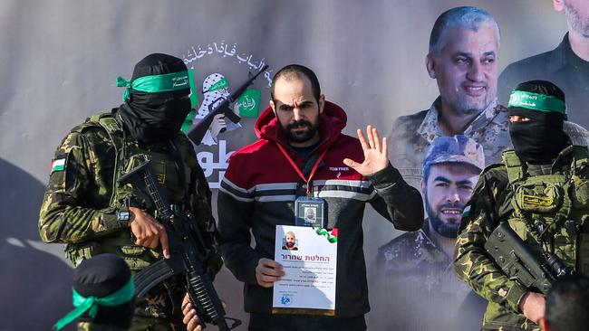 Israeli hostage Yarden Bibas is escorted by Hamas fighters on a stage before the handover. Picture: AFP