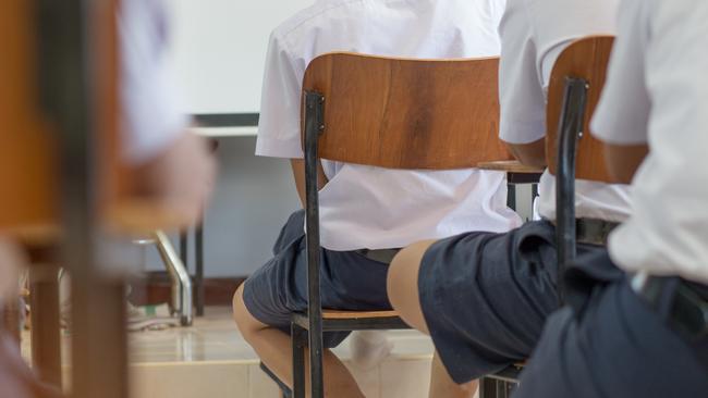 students writing a test exercise, exam paper and multi-choice in classroom, uniform student in Thailand.