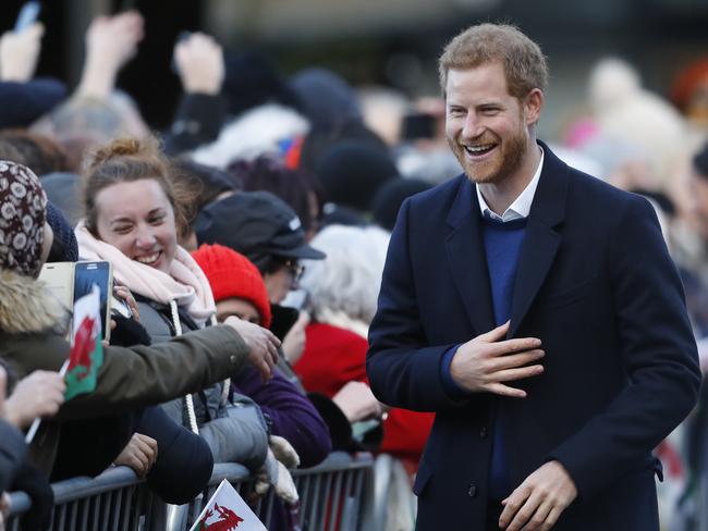 Britain’s Prince Harry laughs as he meets fans as he arrives with his fiancee Meghan Markle for a visit to Cardiff Castle in Cardiff, Wales, Thursday, Jan.18, 2018. Picture: AP
