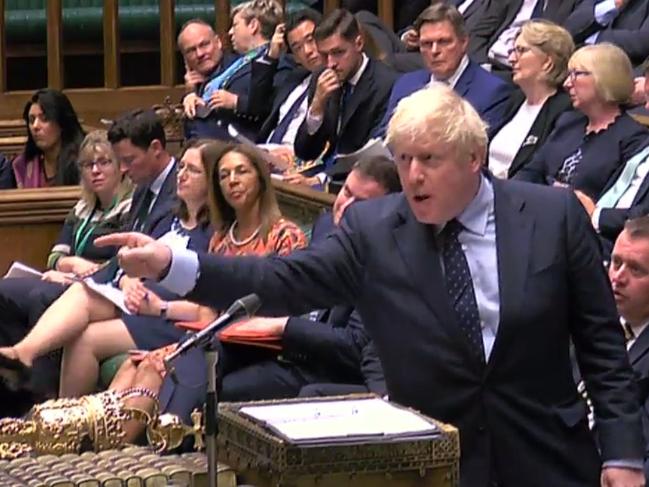 Boris Johnson gestures toward the opposition benches during a heated parliamentary session in London. Picture: AP