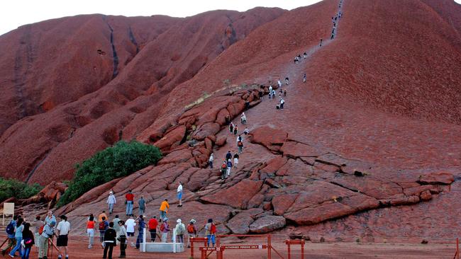 Tourists are flocking to climb Uluru before its closure, leaving behind rubbish and human waste at the sacred site. Picture: AAP