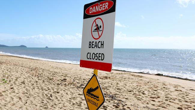 Trinity Beach was closed on Saturday morning when a small saltwater croc was seen swimming close to shore in the stinger net enclosure. Council lifeguards erected a Danger - Beach Closed sign after spotting the crocodile. Picture: Brendan Radke