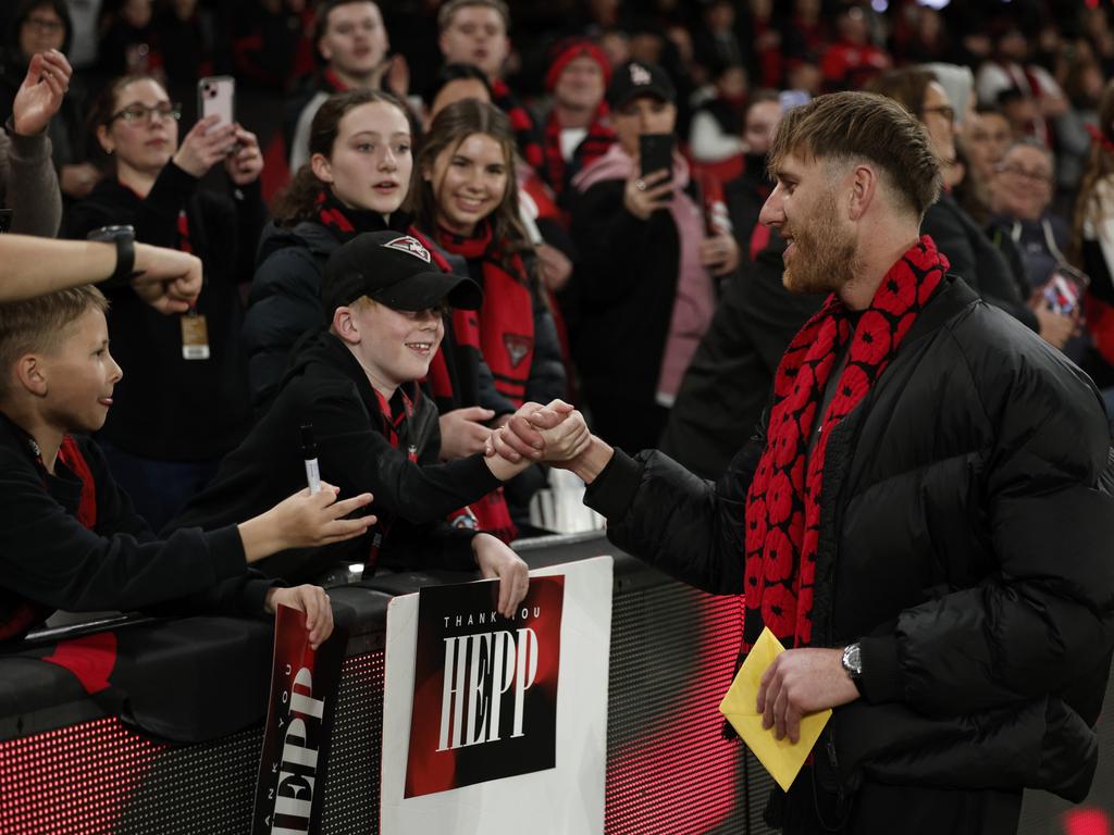 Dyson Heppell of the Bombers greets fans ahead of Friday night’s clash at Marvel Stadium. Picture: Daniel Pockett/Getty Images.