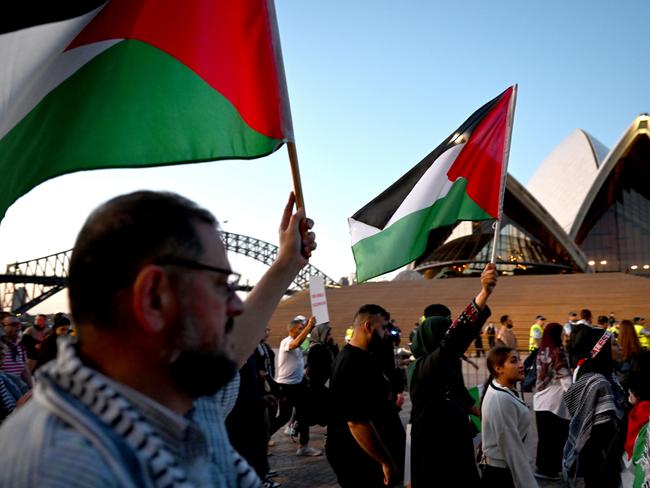 Participants react near the Sydney Opera House during a Free Palestine rally in Sydney, Monday, October 9, 2023. Israel has pounded the Palestinian enclave of Gaza, killing hundreds of people in retaliation for one of the bloodiest attacks in its history when Islamist group Hamas killed 700 Israelis and abducted dozens more. (AAP Image/Dean Lewins) NO ARCHIVING