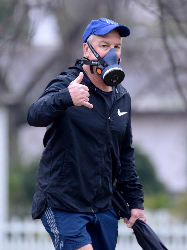 That’s not a mask … THIS is a mask. A man takes no chances while walking the Tan in Melbourne yesterday. Picture: Andrew Henshaw