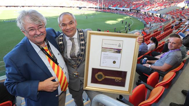 Former editor Bob Gordon pictured getting the keys to the city from Mayor Tom Tate at a presentation Function held at the Metricon Stadium. Pic Mike Batterham