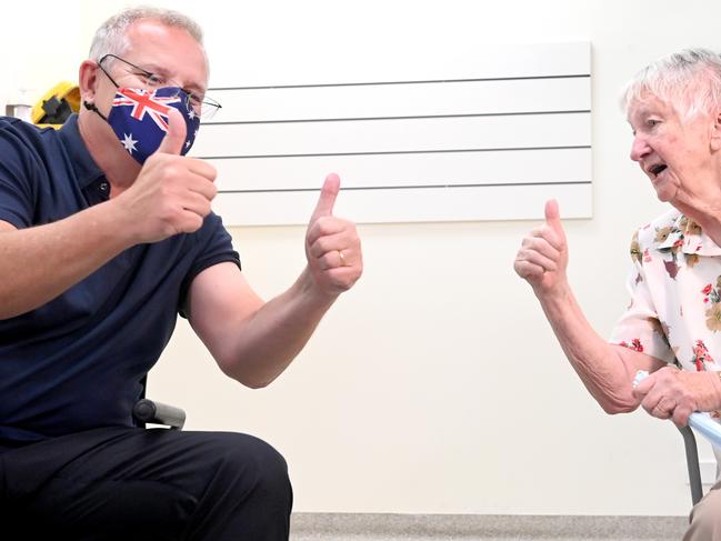 SYDNEY, AUSTRALIA - NewsWire Photos NOVEMBER 19, 2021: Prime Minister Scott Morrison and Jane Malysiak give the thumbs up after receiving their Covid-19  booster shots at the Kildare Road Medical in Blacktown.( POOL via NCA NewsWire)Picture: NCA NewsWire / Jeremy Piper