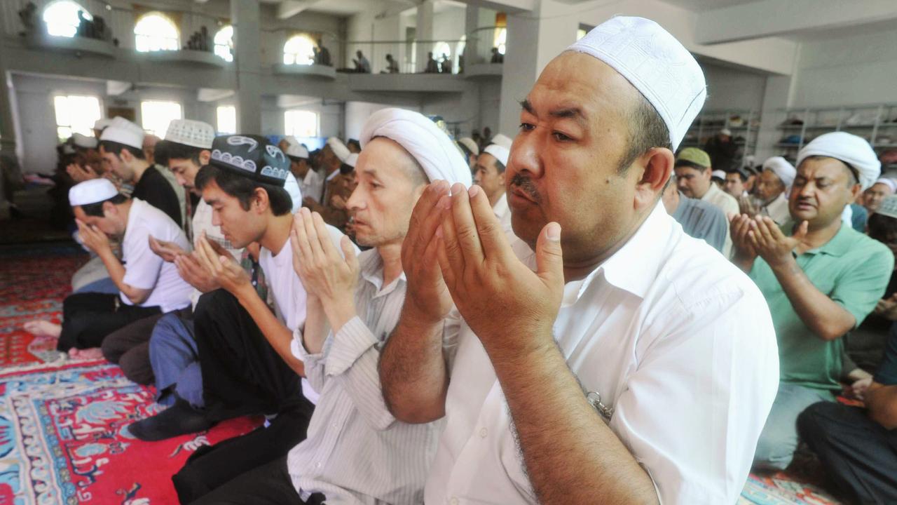 Pictured in 2009, Uighur men pray in a mosque in Urumqi, the capital of the Xinjiang province.