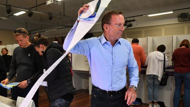 Former prime minister and member for Warringah Tony Abbott receives his ballot papers before voting at Forestville Public School. Picture: Dean Lewins