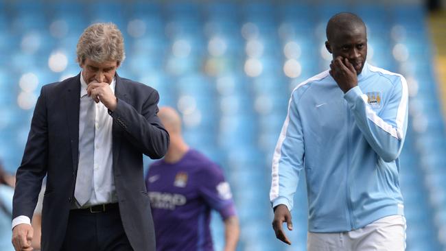 Manchester City's Chilean manager Manuel Pellegrini (L) with Yaya Toure.