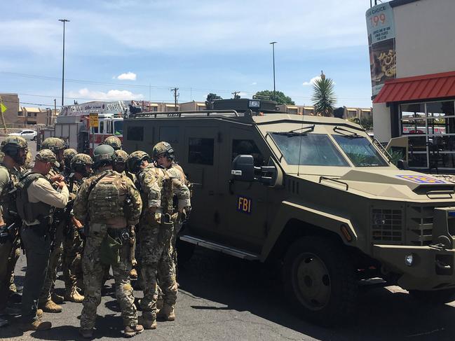 Armed Policemen gather next to an FBI armoured vehicle next to the Cielo Vista Mall. Picture: AFP