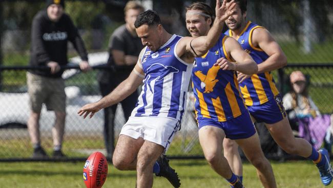 Blake Peach takes a kick for Langwarrin. Picture: Valeriu Campan