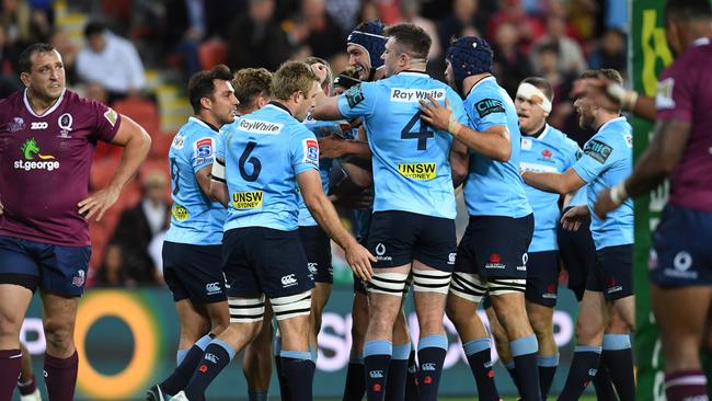 Waratahs players celebrate a try on Saturday night.