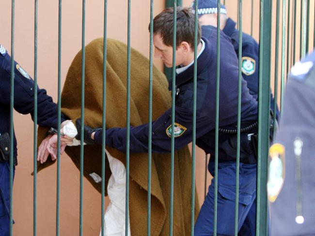 John Walsh is lead into Deniliquin local court during his triple murder case in 2008.