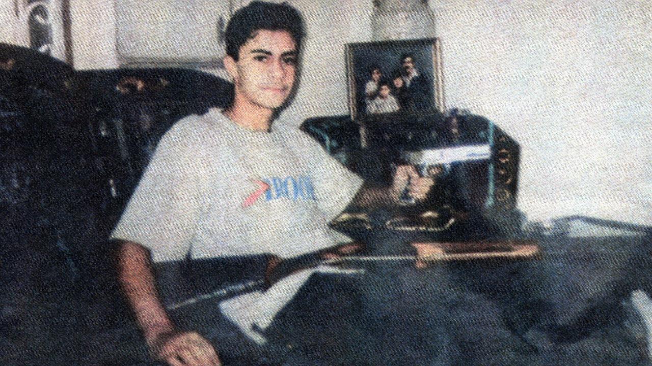 Bilal Skaf in his living room with a pistol and a rifle during his late teens, before his rape arrest.