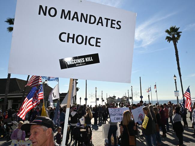 People demonstrate against Covid-19 vaccine mandates for students in Huntington Beach, California on January 3, 2022. - The Los Angeles Unified School District (LAUSD) announced in mid-December itâs decision to delay until fall 2022 its Covid-19 vaccine mandate for students 12 and older who attend class in person.  The original deadline for in-person students to show proof of full vaccination was January 10, 2022. (Photo by Robyn Beck / AFP)