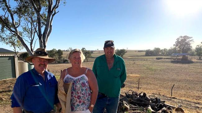 Lisa Hewitt, who helped three drought-affected rural communities with a food drive late last year, with Phil Hunter, left, and Tony Johnson, both sheep farmers from Yeoval. Picture: Supplied