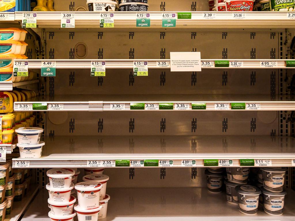Butter and cheese shelves are seen empty at a supermarket in Miami Beach, Florida on January 13, 2022. - The ongoing strains of the coronavirus pandemic have led to sickened workers and staffing shortages for crucial supply-chain functions such as transportation and logistics, which affect the delivery of products and restocking of store shelves. (Photo by CHANDAN KHANNA / AFP)