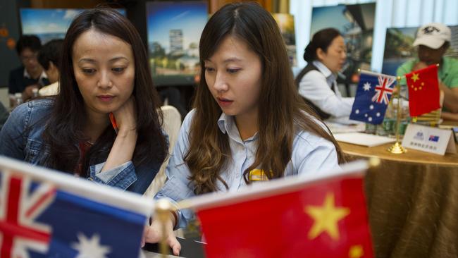 Potential buyers look at Australian apartments at a showcase in Shanghai.