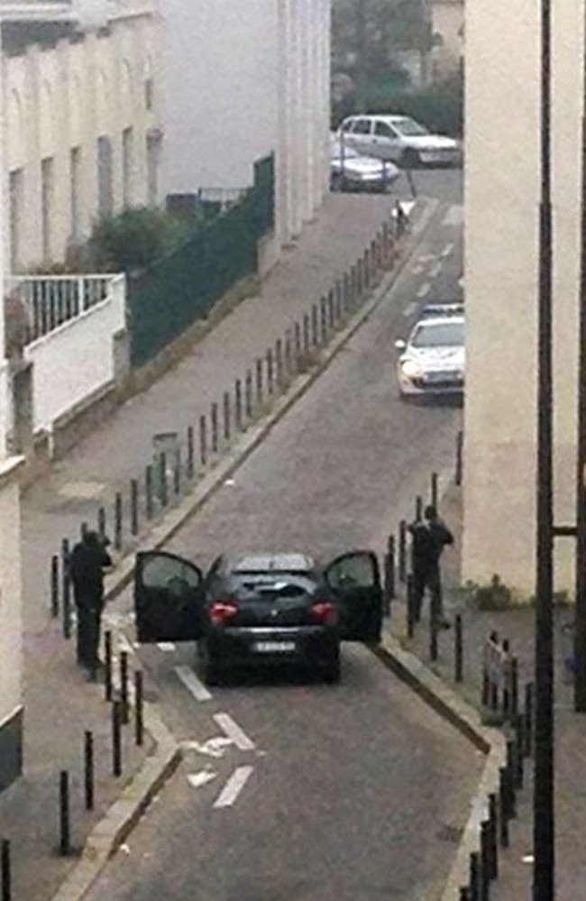 Violent ... armed gunmen face police officers near the offices of the French satirical newspaper Charlie Hebdo. Picture: AFP/Anne Gelbard