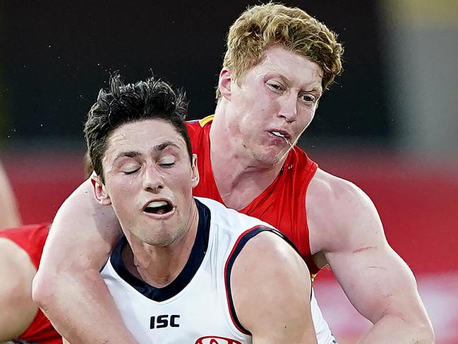 Matthew Rowell of the Suns tackles Chayce Jones of the Crows during the Round 3 AFL match between the Gold Coast Suns and the Adelaide Crows at Metricon Stadium on the Gold Coast, Sunday, June 21, 2020. (AAP Image/Dave Hunt) NO ARCHIVING, EDITORIAL USE ONLY