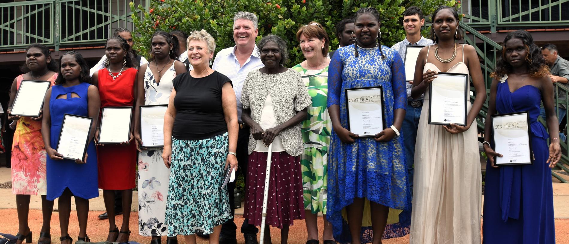 Gunbalanya School co-principal Sue Trimble, Education Department chief executive Karen Weston, Education Minister Mark Monaghan, and 11 NTCET graduates. Picture: Sierra Haigh