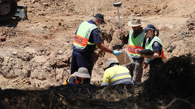 A forensic crime scene investigator with an evidence bag. Picture: Dylan Coker